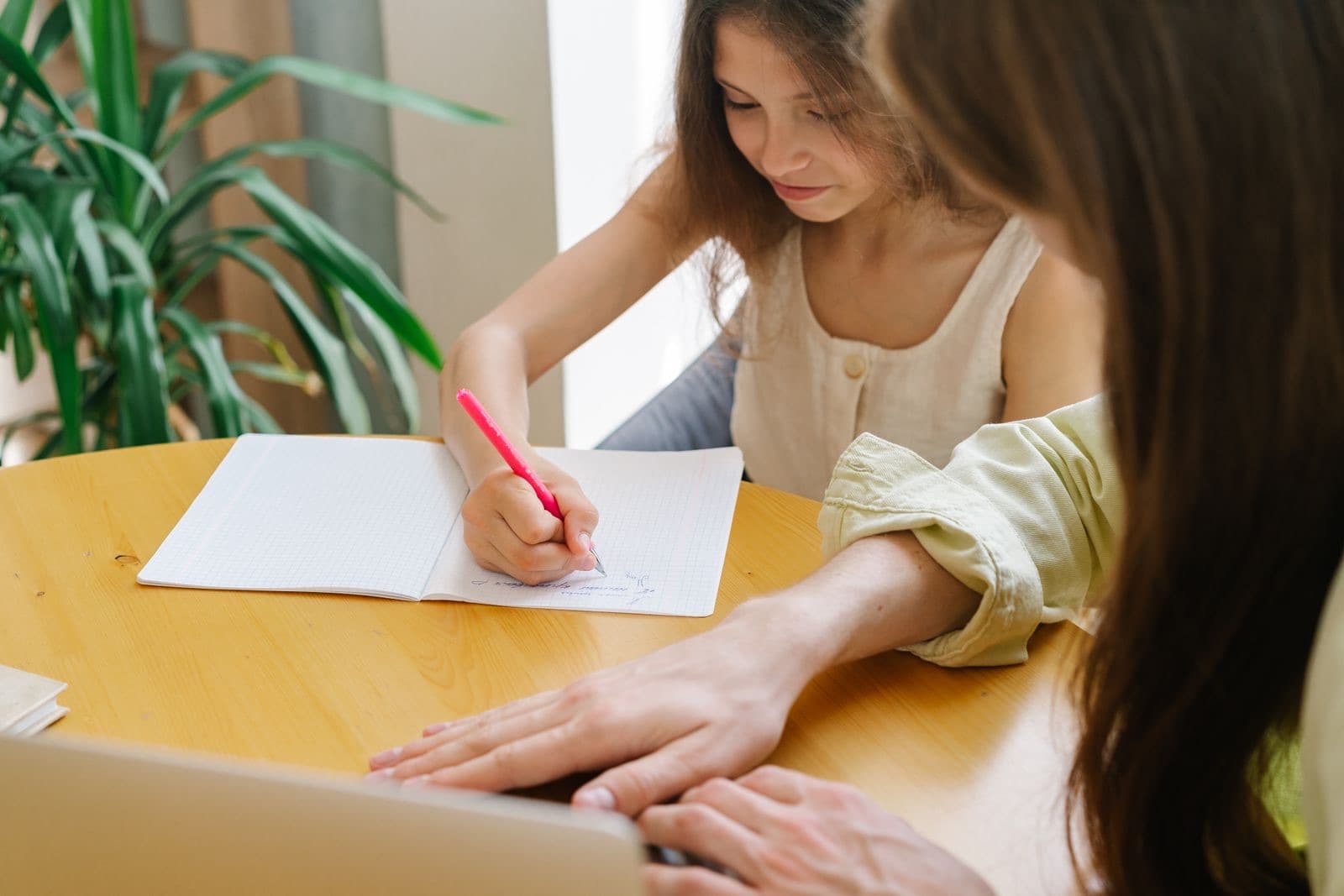 A student writing notes at a desk
